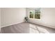Bright bedroom with a large window, neutral walls, and plush carpeting providing a relaxing space at 6202 Kilmer Loop # 202, Golden, CO 80403