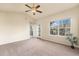 Spacious bedroom featuring ceiling fan, large window, and balcony access at 6202 Kilmer Loop # 202, Golden, CO 80403