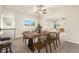 Open concept dining room with a wooden table, chairs, and large windows bringing in natural light at 6202 Kilmer Loop # 202, Golden, CO 80403
