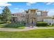 Charming townhome with a well-maintained lawn and stone accents on the facade, perfect for curb appeal at 6202 Kilmer Loop # 202, Golden, CO 80403