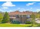 Exterior view of townhome showing manicured lawn, stone accents and professional landscaping at 6202 Kilmer Loop # 202, Golden, CO 80403