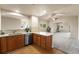 Open-concept kitchen with stainless steel appliances and warm wood cabinetry with an open view into the living space at 6202 Kilmer Loop # 202, Golden, CO 80403