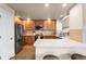Bright kitchen with modern appliances, wooden cabinets, and a breakfast bar, offering convenience and style at 6202 Kilmer Loop # 202, Golden, CO 80403