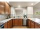 Well-lit kitchen featuring stainless steel appliances, tile backsplash, and a functional layout at 6202 Kilmer Loop # 202, Golden, CO 80403