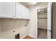 Laundry room with white cabinets, tile flooring, and a doorway to the closet at 6202 Kilmer Loop # 202, Golden, CO 80403