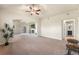Spacious living room features fireplace, TV, ceiling fan, and access to outdoor balcony at 6202 Kilmer Loop # 202, Golden, CO 80403