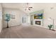 Bright living room with a fireplace, large windows, and access to a balcony, offering a comfortable and stylish space at 6202 Kilmer Loop # 202, Golden, CO 80403