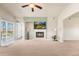 Spacious living room with a fireplace, natural light, and balcony access, designed for comfort and relaxation at 6202 Kilmer Loop # 202, Golden, CO 80403