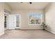 Open living room with neutral carpet, a ceiling fan, and natural light from windows and doors at 6202 Kilmer Loop # 202, Golden, CO 80403