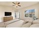 Bright main bedroom featuring a large window, dresser, and access to a balcony at 6202 Kilmer Loop # 202, Golden, CO 80403