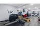 Basement with home gym featuring treadmills, elliptical, weights, and mounted television at 5925 Zinnia Ct, Arvada, CO 80004