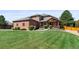 Lovely brick home with a covered front porch and a spacious, well-manicured front lawn at 5925 Zinnia Ct, Arvada, CO 80004