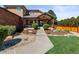 Inviting front entrance featuring manicured landscaping, a covered porch, and a stone walkway leading to the front door at 5925 Zinnia Ct, Arvada, CO 80004