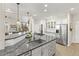 Bright kitchen featuring granite countertops, stainless steel appliances, and tile backsplash at 5925 Zinnia Ct, Arvada, CO 80004