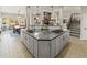 Large kitchen island with granite counters, gas cooktop, and ample storage at 5925 Zinnia Ct, Arvada, CO 80004
