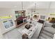Open-concept living room with high ceilings, a cozy fireplace, and large windows offering plenty of natural light at 5925 Zinnia Ct, Arvada, CO 80004