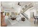 Elegant living room with high ceilings, large windows, and a staircase leading to the upper level at 5925 Zinnia Ct, Arvada, CO 80004