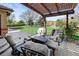 Outdoor living at its finest with a cozy patio, stone columns, and pergola at 5925 Zinnia Ct, Arvada, CO 80004
