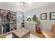 Spacious walk-in closet with custom shelving, drawers, ottoman, and bright natural light at 5925 Zinnia Ct, Arvada, CO 80004