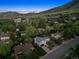 Stunning aerial view of neighborhood with green trees and nearby mountain range at dusk at 1931 Foothills Rd, Golden, CO 80401