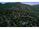 Aerial view of a residential neighborhood nestled against a mountain backdrop at twilight at 1931 Foothills Rd, Golden, CO 80401