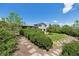 Landscaped backyard featuring a stone path, manicured bushes, and a view of the well-maintained lawn at 1931 Foothills Rd, Golden, CO 80401