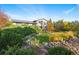 Expansive backyard featuring lush landscaping, mature trees, and a well-maintained lawn at 1931 Foothills Rd, Golden, CO 80401
