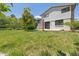 Expansive backyard with lush lawn and mature trees, perfect for outdoor activities and relaxation at 1931 Foothills Rd, Golden, CO 80401