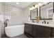 Modern bathroom with a soaking tub, double vanity, and stylish tile at 1931 Foothills Rd, Golden, CO 80401