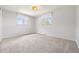 Neutral bedroom with two windows, a light fixture, and carpet flooring at 1931 Foothills Rd, Golden, CO 80401