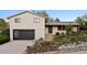 Charming split-level home featuring a modern two-car garage and beautifully landscaped front yard at 1931 Foothills Rd, Golden, CO 80401