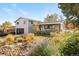 Charming front yard with beautifully landscaped garden, mature trees, and inviting curb appeal at 1931 Foothills Rd, Golden, CO 80401