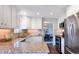 Bright kitchen featuring granite countertops, stainless steel appliances, and white cabinetry at 1931 Foothills Rd, Golden, CO 80401