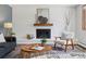 Comfortable living room featuring a brick fireplace, modern decor, and hardwood floors at 1931 Foothills Rd, Golden, CO 80401