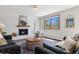 Bright living room with a brick fireplace, large windows with green views at 1931 Foothills Rd, Golden, CO 80401
