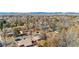 Scenic aerial view of neighborhood homes, mountains, and tree-lined streets under a sunny blue sky at 6359 Brooks Dr, Arvada, CO 80004