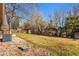 Large backyard with grass, mature trees, shed, and partial fence, perfect for outdoor activities at 6359 Brooks Dr, Arvada, CO 80004