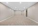 Large, open carpeted basement area with neutral walls and recessed lighting offers versatile living space at 6359 Brooks Dr, Arvada, CO 80004