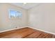 Bedroom featuring hardwood floors, neutral walls, ceiling fan and a large window at 6359 Brooks Dr, Arvada, CO 80004