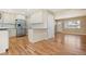 Modern kitchen with stone countertops, white cabinets, stainless steel appliances, and hardwood floors at 6359 Brooks Dr, Arvada, CO 80004