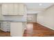Spacious kitchen open to living area with granite countertops and bright white cabinetry at 6359 Brooks Dr, Arvada, CO 80004