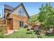 A backyard patio featuring artificial turf, a fire pit, and seating at 220 Wark Ave, Berthoud, CO 80513