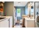 Cozy bathroom with a washer and dryer, with white vanity and neutral walls that offers practical convenience and comfort at 220 Wark Ave, Berthoud, CO 80513