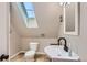 Bathroom featuring a skylight, toilet, and sink vanity at 220 Wark Ave, Berthoud, CO 80513
