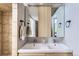 Bathroom featuring double sinks beneath a large mirror, exuding a bright and contemporary aesthetic at 220 Wark Ave, Berthoud, CO 80513