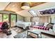 Bedroom with wooden ceiling, bed, sofa, and a door that leads outside at 220 Wark Ave, Berthoud, CO 80513