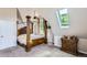 Spacious bedroom features a four-poster bed and skylight, creating a tranquil retreat with natural light and comfort at 220 Wark Ave, Berthoud, CO 80513