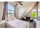 Bedroom featuring a large arched window, ceiling fan, and pink accents at 220 Wark Ave, Berthoud, CO 80513