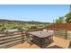Deck with a table and seating overlooking mountains at 220 Wark Ave, Berthoud, CO 80513