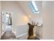 Upstairs hallway with skylight and an animal head displayed near an open bedroom doorway at 220 Wark Ave, Berthoud, CO 80513